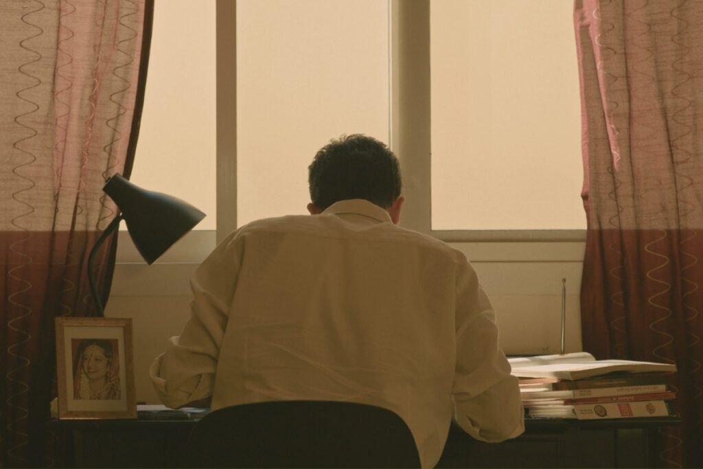 A young chef seated at a desk, studying late into the night, in a scene from Chronicles of a Chef Episode 1: ROOTS.